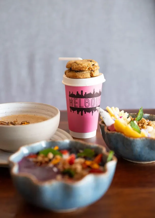 Melbourne café branded pink takeaway cup with cookies and breakfast bowls, Cherngtalay Phuket