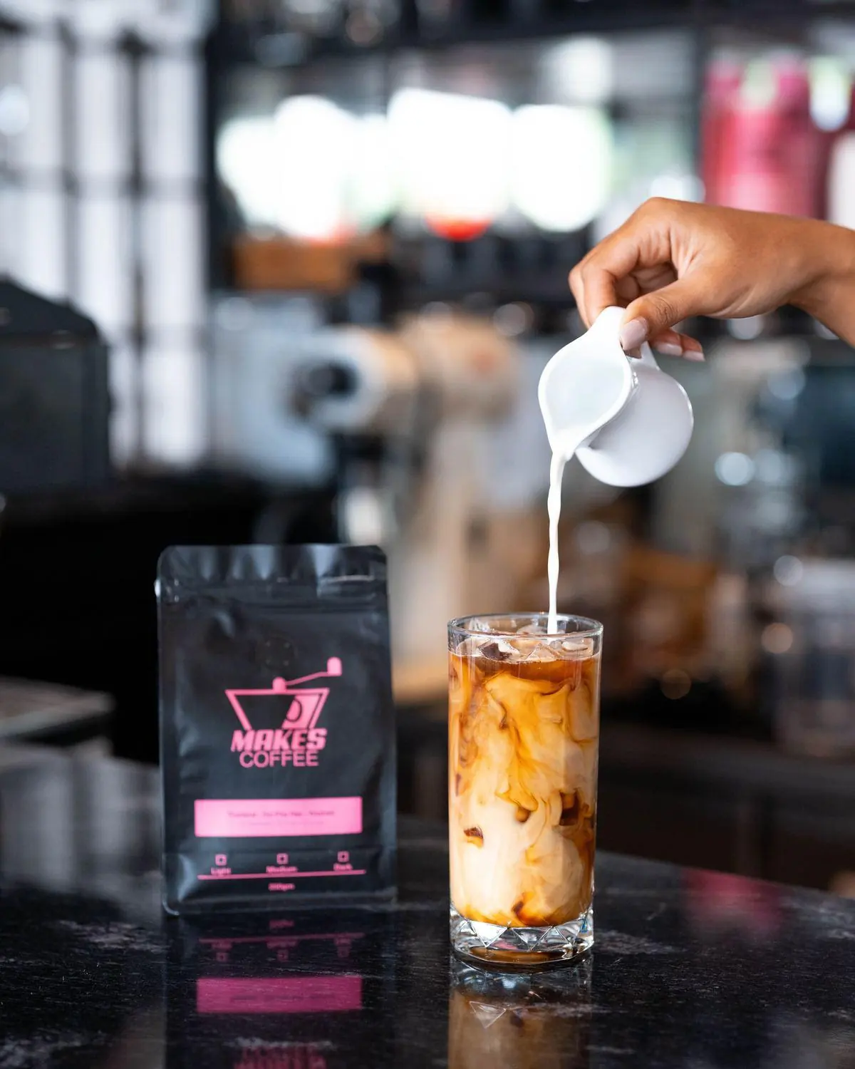 Iced latte being poured at Melbourne café with Makes Coffee bag, specialty coffee Phuket